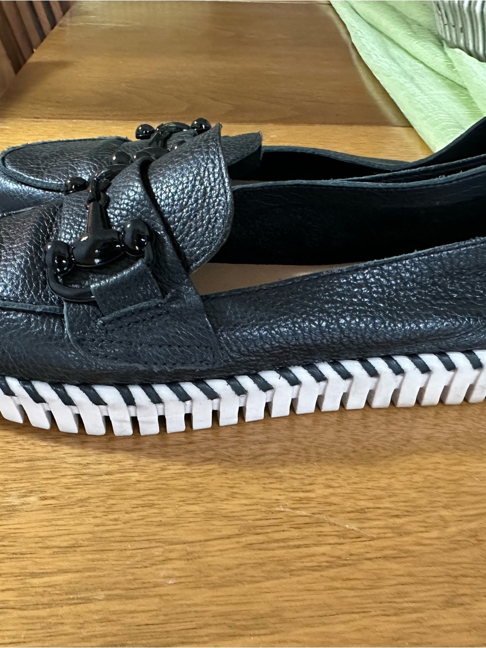 Black Leather Loafer with Decorative Hardware and White Trim